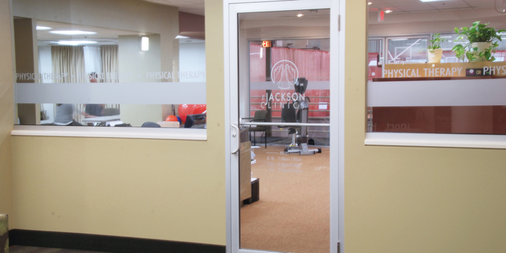 Front door to clinic suite with logo that reads The Jackson Clinics Physical Therapy