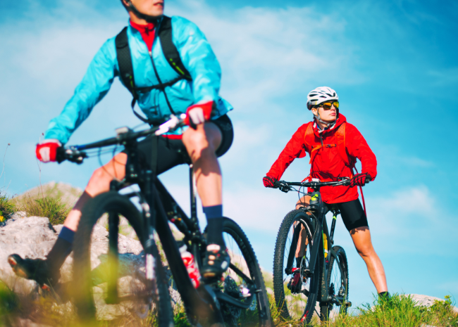 Two men cycling outside