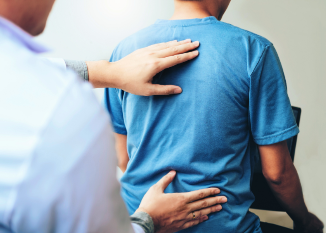 Physical therapy for your back: physical therapist assessing patient's back