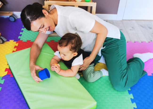 Pediatric physical therapy between mom and child at home