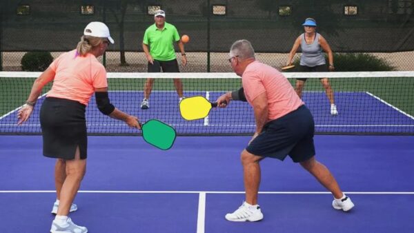 Elderly couples playing pickleball while being mindful of pickleball injuries.