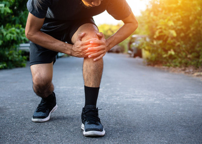 Knee pain Male struggling with knee pain from running injury