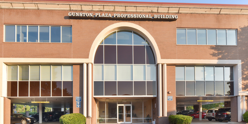 outside of building where clinic is located with sign that reads Gunston Plaza Professional Building