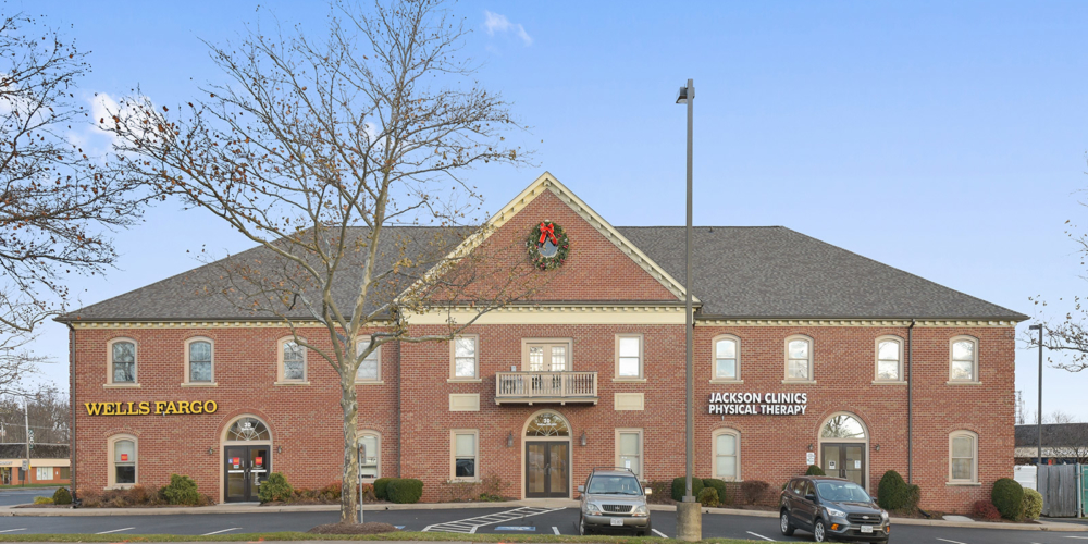 outside of building where clinic is located with a sign that reads The Jackson Clinics Physical Therapy