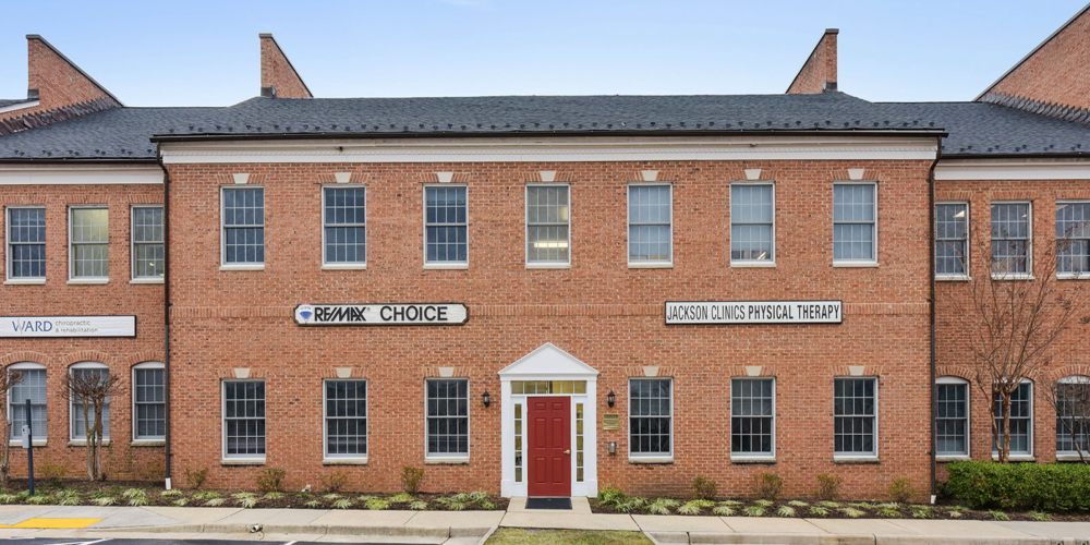 outside of building where clinic is located with sign that reads The Jackson Clinics Physical Therapy