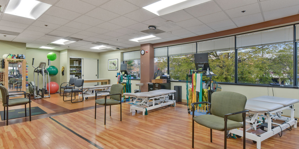 physical therapy area with equipment and tables