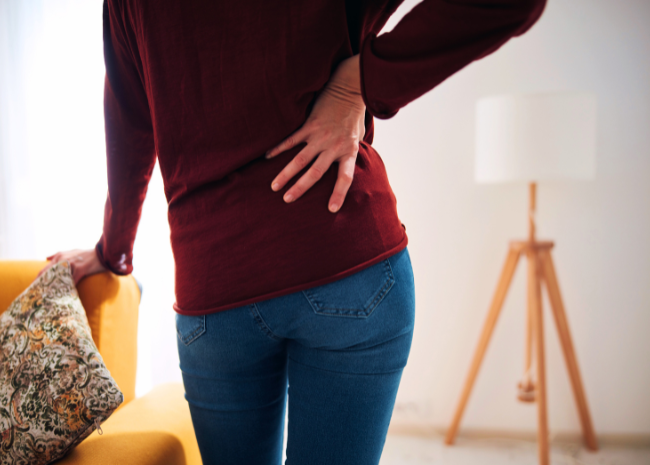 woman struggling with hip pain, touching hip, needs physical therapy for hip pain