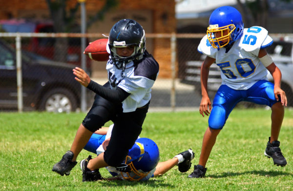 youth sports athlete breaking a tackle
